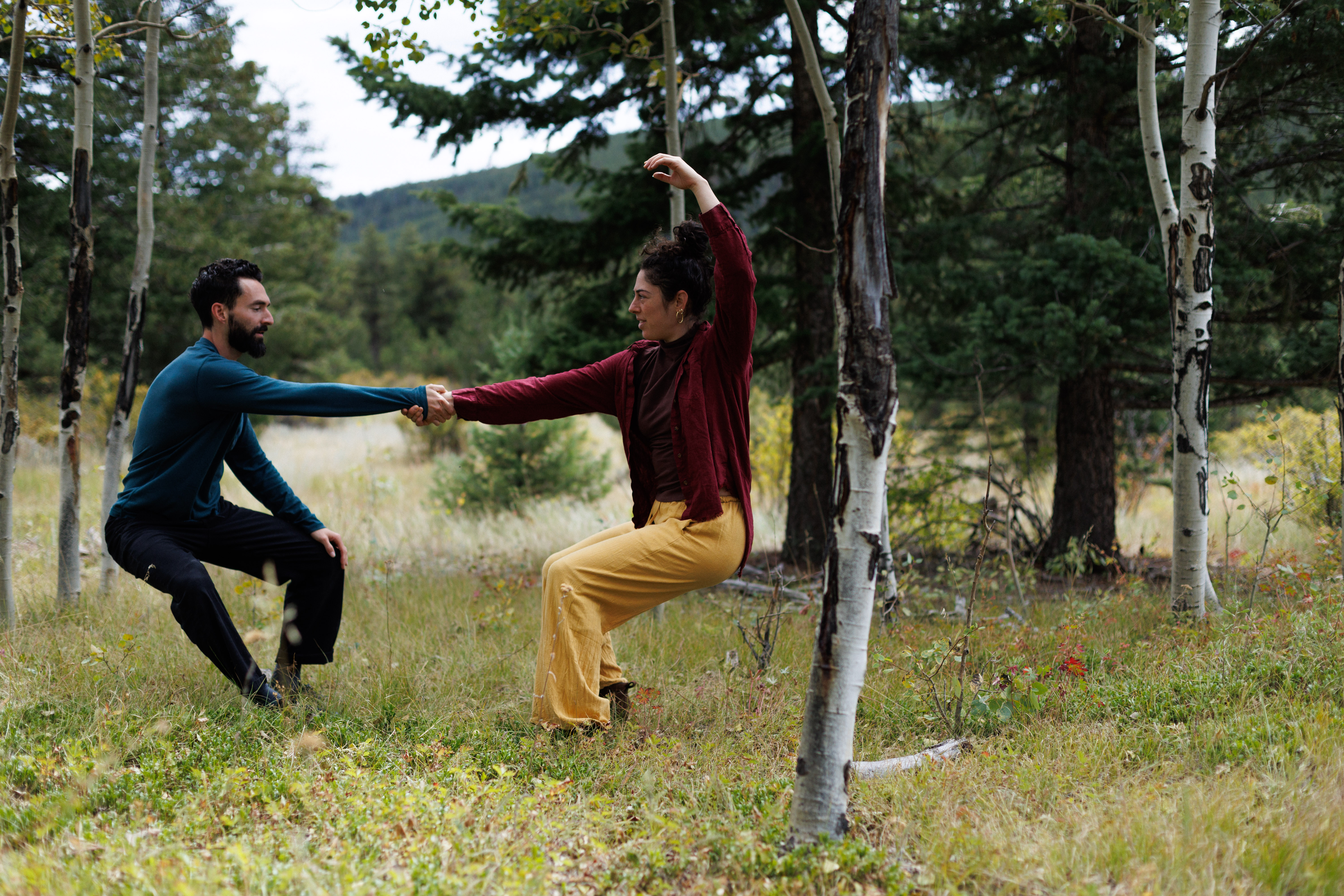 Two dancers in contact improvisation in an aspen forest